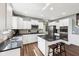 This is a gorgeous kitchen with an island, granite countertops, stainless appliances, and white cabinets at 123 Bentree Blvd, Danville, IN 46122