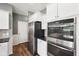 This is a stainless steel fridge and double oven with granite countertops and white cabinets at 123 Bentree Blvd, Danville, IN 46122