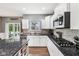 This is a bright kitchen with an island, stainless appliances, and white cabinets with granite countertops at 123 Bentree Blvd, Danville, IN 46122