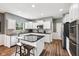 This is a gorgeous kitchen with an island, granite countertops, stainless appliances, and white cabinets at 123 Bentree Blvd, Danville, IN 46122