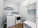 This is a laundry room with a new washer, dryer, cabinets, and hard surface floors at 123 Bentree Blvd, Danville, IN 46122