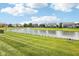 Scenic view of a neighborhood pond with a fountain surrounded by green lawns and well-maintained homes at 123 Bentree Blvd, Danville, IN 46122