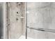 The tiled shower has a glass door and a handheld shower attachment at 123 Bentree Blvd, Danville, IN 46122