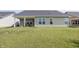 Backyard has green lawn that backs up to neighboring houses with minimal landscaping at 1283 Clairet, Westfield, IN 46074