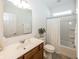 Bright bathroom featuring a vanity with a marble countertop, toilet, and a shower/tub combination with a white curtain at 1283 Clairet, Westfield, IN 46074