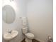 Half bathroom featuring a pedestal sink, round mirror, and a toilet with towel rack, for a convenient space at 1283 Clairet, Westfield, IN 46074