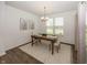 Bright dining area features modern chandelier, wooden table set with rug and lots of natural light at 1283 Clairet, Westfield, IN 46074