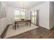 Bright dining area features modern chandelier, wooden table set with rug and lots of natural light at 1283 Clairet, Westfield, IN 46074