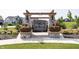 Stone and wood Bordeaux Walk entrance sign with flowers and green lawns at 1283 Clairet, Westfield, IN 46074
