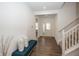 Bright and welcoming foyer featuring hardwood floors, a cozy bench, and staircase leading to the upper level at 1283 Clairet, Westfield, IN 46074