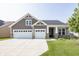 Charming home featuring a three-car garage, stone accents, and manicured lawn, with an inviting facade and neutral color palette at 1283 Clairet, Westfield, IN 46074
