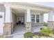 Welcoming covered front porch with stone pillars, manicured flower beds, and stylish entry door creates inviting curb appeal at 1283 Clairet, Westfield, IN 46074