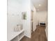 Inviting hallway entrance with bench seating and coat hooks leading to a laundry area with wood-look flooring at 1283 Clairet, Westfield, IN 46074