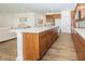 Spacious kitchen boasts stainless appliances, wooden cabinets, and an island with a white countertop at 1283 Clairet, Westfield, IN 46074