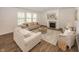 Bright living room featuring neutral furniture, fireplace, large windows, and hardwood flooring for a warm and inviting atmosphere at 1283 Clairet, Westfield, IN 46074