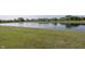Scenic view of pond surrounded by green grass and suburban homes in the distance at 1283 Clairet, Westfield, IN 46074