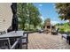Large backyard with outdoor fireplace, dining area, and lush landscaping at 1345 Lewiston Dr, Westfield, IN 46074