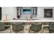 Modern basement bar featuring counter seating, a TV, and decorative backsplash for entertaining at 1345 Lewiston Dr, Westfield, IN 46074