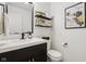 Modern powder room with a sleek vanity, black fixtures, floating shelves, and contemporary decor at 1345 Lewiston Dr, Westfield, IN 46074