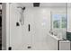 Modern walk-in shower with white subway tile, geometric flooring, and rain shower head at 1345 Lewiston Dr, Westfield, IN 46074