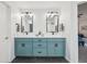 Well-lit bathroom featuring a double vanity, black framed mirrors and updated fixtures at 1345 Lewiston Dr, Westfield, IN 46074