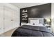 A well-lit bedroom featuring a black accent wall and closet space with an overhead light at 1345 Lewiston Dr, Westfield, IN 46074