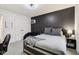A modern bedroom featuring a basketball hoop, dark accent wall, and neutral decor at 1345 Lewiston Dr, Westfield, IN 46074