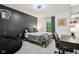 A stylish bedroom with dark accent wall, gray bedding, and a cozy beanbag chair at 1345 Lewiston Dr, Westfield, IN 46074