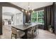 Chic dining room with dark walls, a modern chandelier, hardwood floors, and a large window at 1345 Lewiston Dr, Westfield, IN 46074