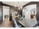 Stylish dining room with dark walls, a modern chandelier, hardwood floors, and an open floor plan at 1345 Lewiston Dr, Westfield, IN 46074