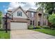 Charming brick two-story home featuring a large driveway and attached two-car garage at 1345 Lewiston Dr, Westfield, IN 46074
