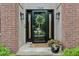 Stylish front door entrance framed by brick columns, sconces, and well-kept landscaping at 1345 Lewiston Dr, Westfield, IN 46074