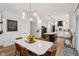 Bright kitchen with white cabinets, stainless steel appliances, hardwood floors, and open to the dining area at 1345 Lewiston Dr, Westfield, IN 46074