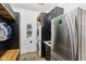 A convenient laundry room features a stacked washer/dryer unit, sink, cabinets, and a spot for backpacks at 1345 Lewiston Dr, Westfield, IN 46074