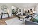 Bright living room features hardwood floors, a gray sofa set, and staircase leading to the upper level at 1345 Lewiston Dr, Westfield, IN 46074