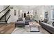 Open living room with hardwood floors showcases a large sectional sofa at 1345 Lewiston Dr, Westfield, IN 46074