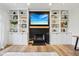 Inviting living room featuring a cozy fireplace, built-in bookshelves, and hardwood flooring at 1345 Lewiston Dr, Westfield, IN 46074