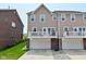 Townhouse back exterior with white-railed decks over garages and neutral siding at 13616 Whitten N Dr, Fishers, IN 46037