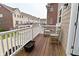 Cozy balcony features wooden chairs and table for relaxing outdoor living in a suburban neighborhood at 13616 Whitten N Dr, Fishers, IN 46037