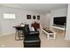 Finished basement boasting a dark leather sofa, workstation, and tv at 13616 Whitten N Dr, Fishers, IN 46037