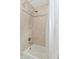 Clean bathroom featuring a shower and white tub with tiled walls at 13616 Whitten N Dr, Fishers, IN 46037