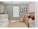 Comfortable Bedroom with a rocking chair, crib, and a soft, neutral color palette at 13616 Whitten N Dr, Fishers, IN 46037