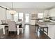 Open dining area featuring modern light fixture, dining table, and seamless flow to kitchen at 13616 Whitten N Dr, Fishers, IN 46037