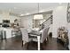 Open-concept dining area with modern table, bar stools, and stylish decor at 13616 Whitten N Dr, Fishers, IN 46037