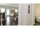 Hallway view showcases wood floors, access to bathroom, and open layout to kitchen at 13616 Whitten N Dr, Fishers, IN 46037