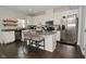 Bright kitchen featuring white cabinets, granite countertops, and a stainless steel refrigerator at 13616 Whitten N Dr, Fishers, IN 46037