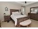 A relaxing main bedroom features a tray ceiling, neutral color palette, and wood furnishings at 13616 Whitten N Dr, Fishers, IN 46037