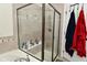 Modern walk-in shower featuring tiled walls and a glass enclosure with silver fixtures at 13616 Whitten N Dr, Fishers, IN 46037
