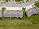 Aerial view of the townhouse roofs surrounded by green grass, access roads and landscaping at 14110 Bay Willow Dr, Fishers, IN 46037