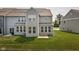 Backyard view of the grey townhomes and green grass at 14110 Bay Willow Dr, Fishers, IN 46037